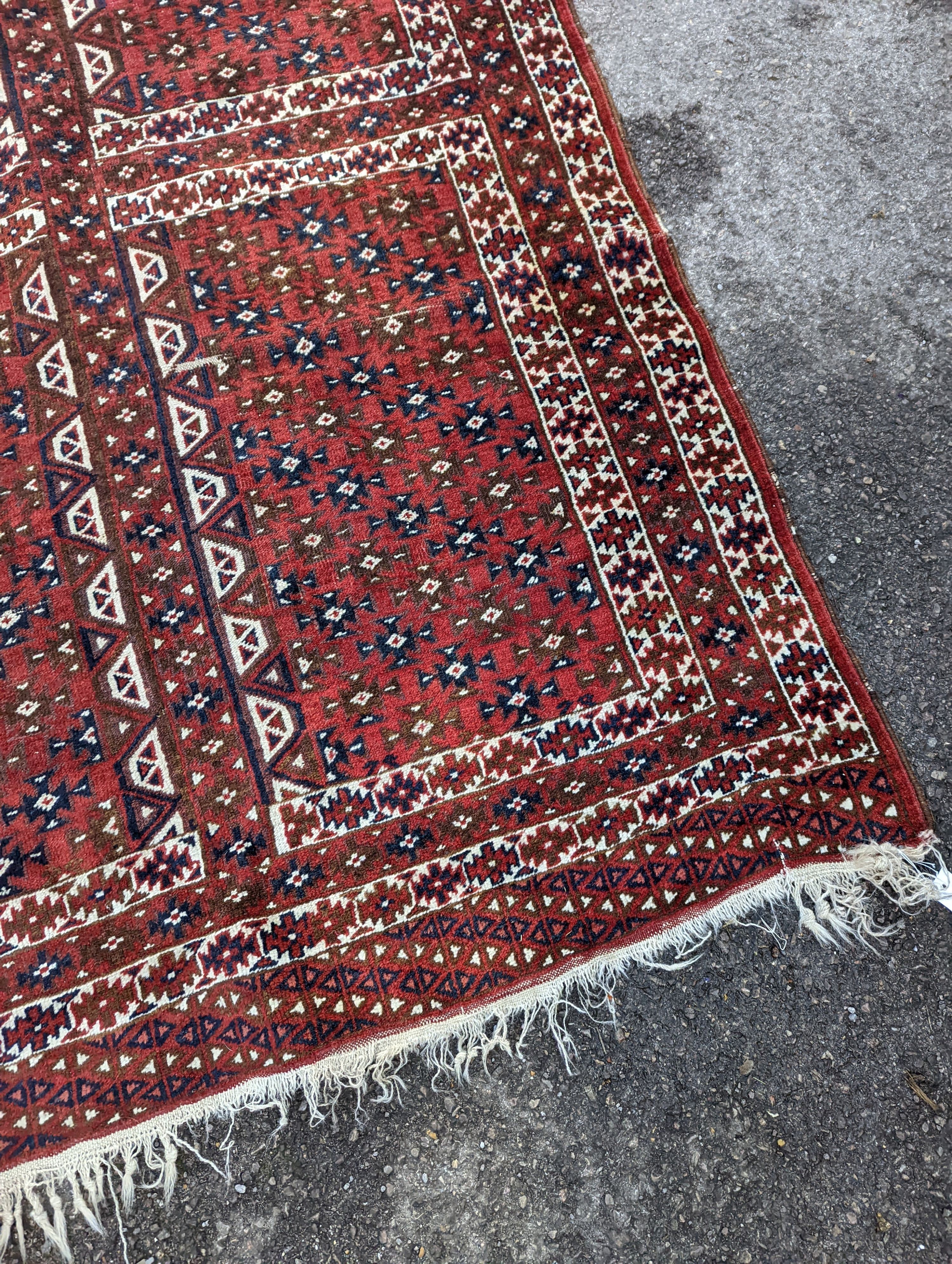 A Belouch red ground rug, 200 x 130cm